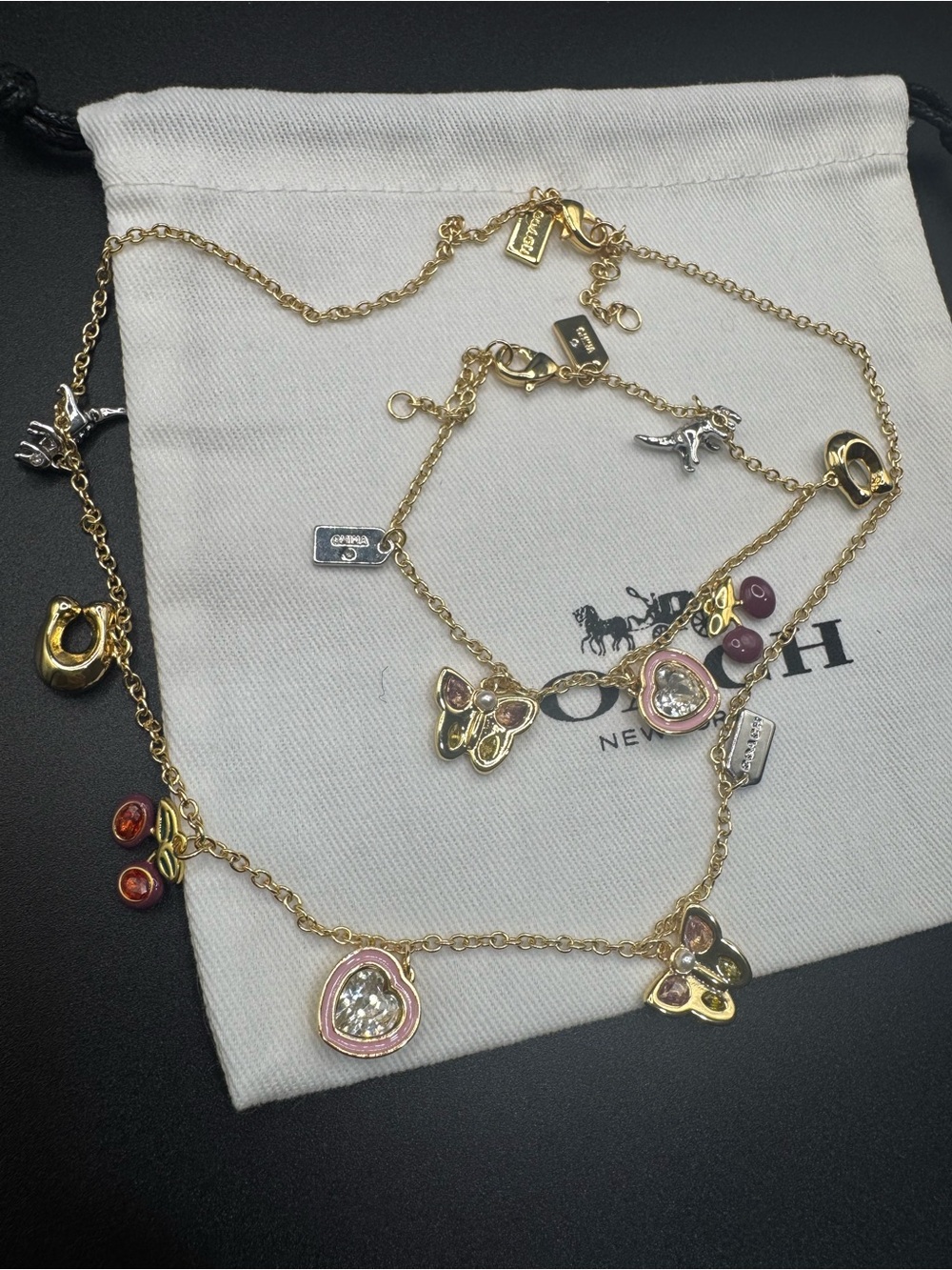 Coach Gold-Tone Necklace and Bracelet with Pink and Red Accent Charms